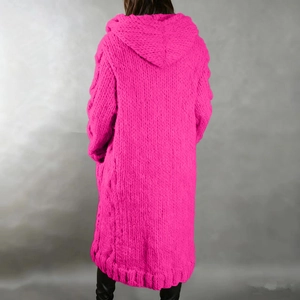 Macro detail of chunky knit texture and back hood on vibrant pink long cardigan