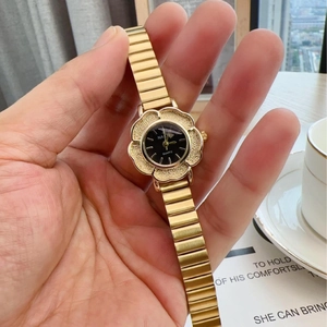 Vintage gold women's watch featuring a unique flower-shaped case and stretchy strap