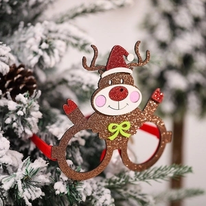 Glittery reindeer Christmas glasses frame with a Santa hat on a snowy tree branch