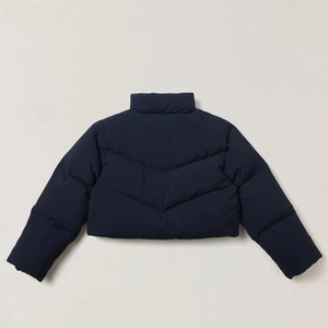 Detail view of navy blue cropped down jacket back showing V-shaped quilted stitching
