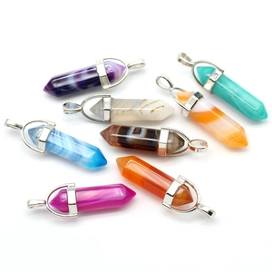 Macro shot of eight hexagonal natural agate crystal pendants in various vibrant colors