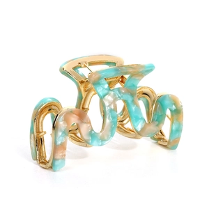 Large snake-shaped acetate hair claw clip with wavy gold metal frame in green marble