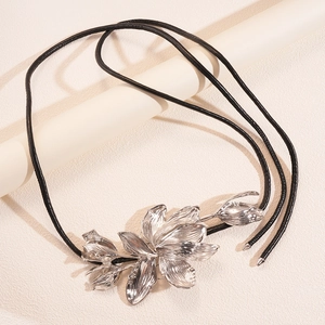 Détail du pendentif fleur tulipe argentée avec cordon en cuir noir et finition texturée