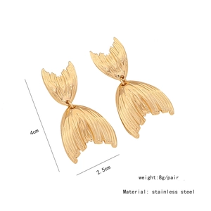 Detailed view of gold fishtail earrings in stainless steel with textured metal finish
