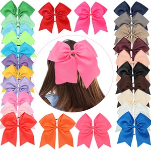 Detail view of colorful bow hair clips in various vibrant shades for girls' hairstyles