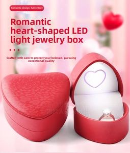 Macro detail of red heart-shaped jewelry box with bright LED light for rings