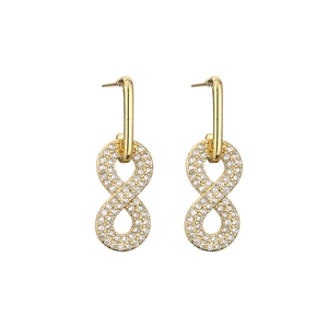 Detail of 18k gold plated infinity cross earrings with sparkling inlaid micro diamonds