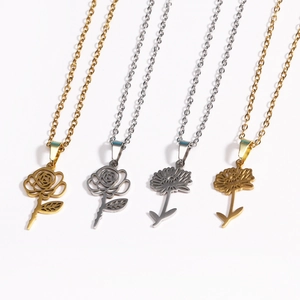 Detailed view of 18k gold and silver floral pendant necklaces in diverse flower styles
