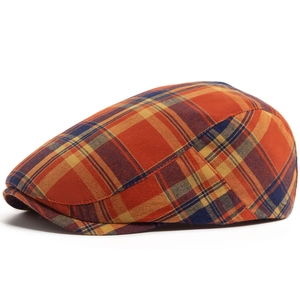 Vintage checkered beret hat in orange, yellow and blue plaid pattern for a classic retro look