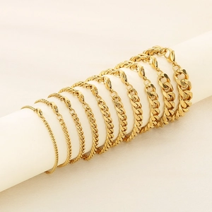 Multiple sizes of 18K gold plated Cuban chain bracelets with lobster clasp on white prop