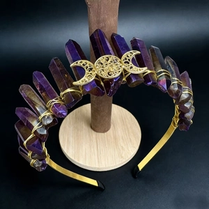 Detail of bohemian crown with purple crystal pillars and golden moon symbol