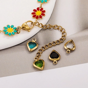 Gold stainless steel bracelet featuring colorful enamel flowers and heart shaped crystal charms