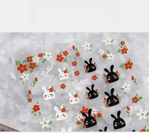 Detail of 5D thin nail stickers featuring black and white rabbit and floral patterns