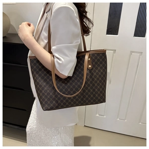 Detailed view of women's tote bag featuring vintage pattern and slim leather straps