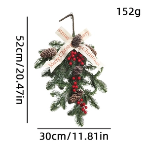 Artificial Christmas wreath with pine needles, red berries, cones and Merry Christmas ribbon