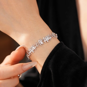 Close-up of a silver zircon square link bracelet with elegant rectangular stones