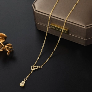 Elegant gold titanium steel gourd necklace with sparkling cubic zirconia on jewelry box