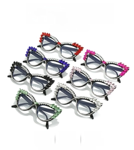 Detailed overhead view of oversized cat-eye frames with colorful large rhinestone accents