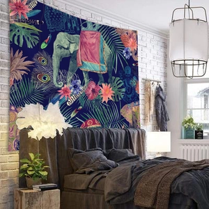 Dark blue bohemian tapestry with elephant and tropical floral motifs on white brick wall