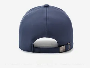 Detail of navy baseball cap back featuring adjustable metal buckle and brand logo