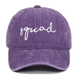 Detailed view of purple washed cotton baseball cap with white squad script embroidery