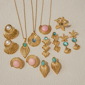 Detailed close-up of golden shell and starfish jewelry set with colorful gemstones