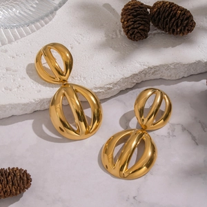 Exaggerated geometric hollow gold stainless steel earrings on a luxury stone display