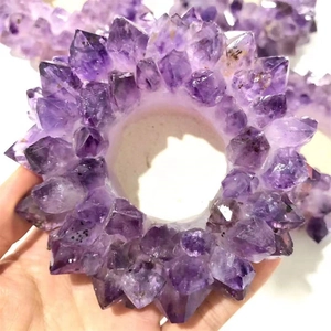 Detailed close-up of natural purple amethyst crystal cluster in a unique circular ring shape