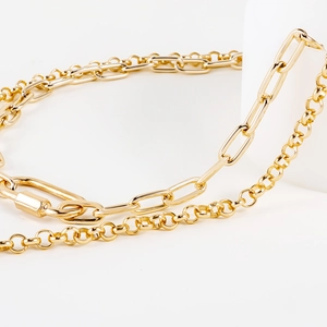 Detail of double-layer gold chain with paperclip links and carabiner clasp decoration