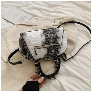 Detail of gradient snakeskin texture shell bag with black ring handle and zipper