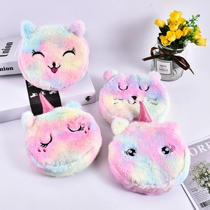 Detailed close-up of rainbow plush coin purses with cute cat faces and unicorn horns