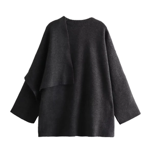 Close-up of black knitted cardigan fabric showing high-quality asymmetric texture