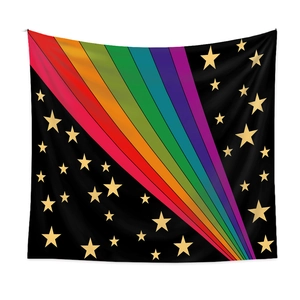 Detail of bohemian rainbow tapestry with golden stars on black fabric background