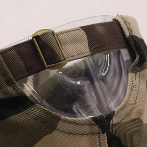 Macro view of camouflage baseball cap back with vintage copper metal adjustment buckle