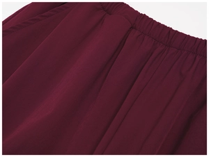 Close-up of flexible elastic waistband on burgundy lightweight wide-leg sun protection pants