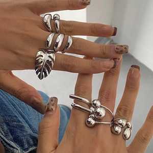 Minimalist silver stainless steel rings featuring geometric leaf and spherical designs