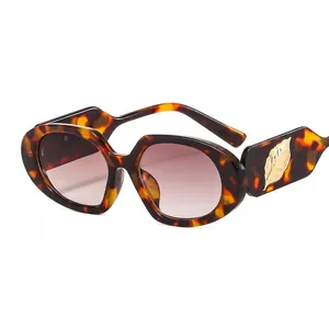 Oval tortoiseshell sunglasses with gold leaf decor and purple gradient lenses