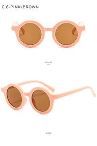 Front and 45-degree side views of round matte pink kids sunglasses with brown lenses