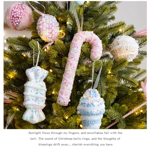 Pink and blue foam candy cane and ball ornaments hanging on a decorated Christmas tree