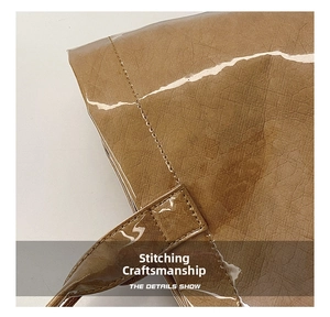 Macro detail of reinforced stitching on brown Tyvek paper bag with glossy finish
