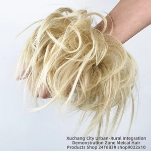 Macro shot of 24T613 light blonde messy hair bun piece showing wavy synthetic texture