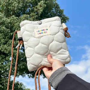 Chic quilted crossbody phone bag in off-white featuring round stitching and cord strap