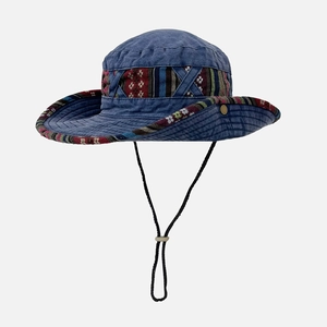 Detail of denim blue sun hat with ethnic striped band and adjustable windproof cord