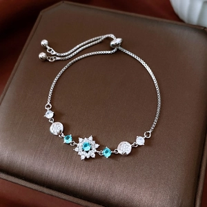 Macro detail of snowflake zircon bracelet with adjustable silver sliding box chain clasp