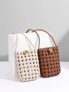 Minimalist woven vertical crossbody phone bags in cream and brown with gold metal buckle