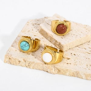 Detailed close-up of 18K gold-plated adjustable rings with turquoise and natural stones