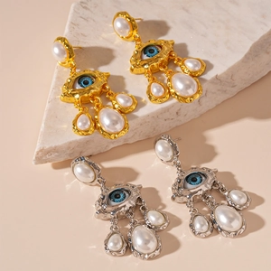 Boucles d'oreilles vintage œil bleu avec perles et finitions métal martelé or et argent