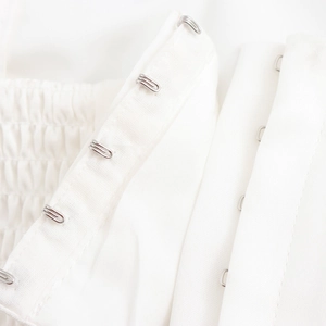 White 3D floral crop top featuring detailed hook-and-eye closure and smocked elastic panel