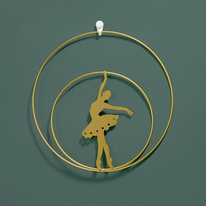 Golden metal wall decor featuring an elegant ballerina silhouette in double round frames