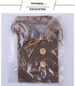 Detail of herringbone wine bottle vest with wood buttons and faux fur collar in packaging